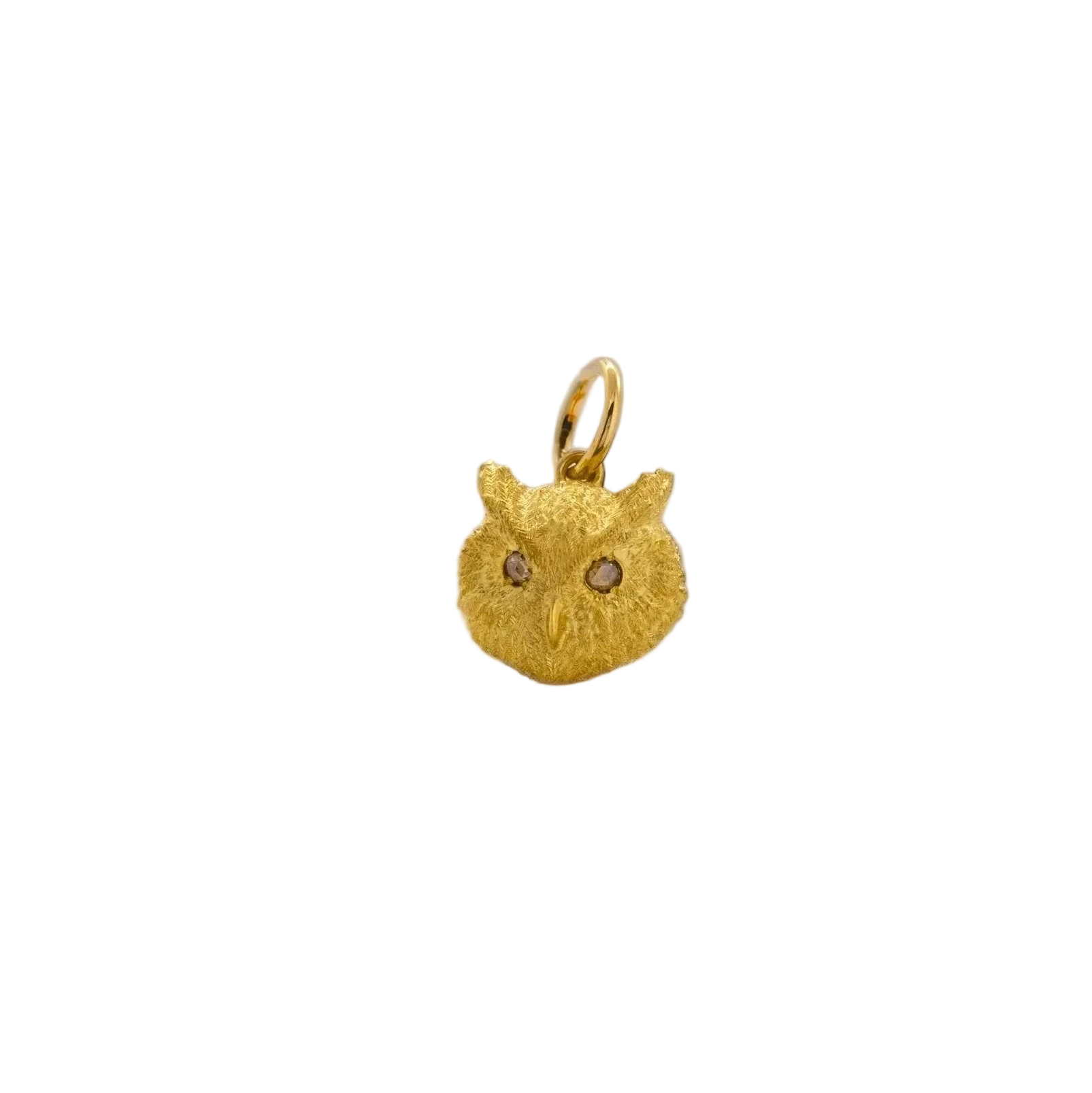 A small gold owl-shaped pendant charm with textured fur-like detailing and tiny dark eyes, shown on a plain white background.