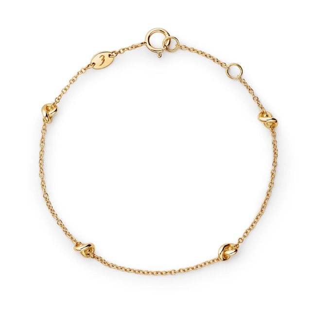 Gold bracelet on a white background