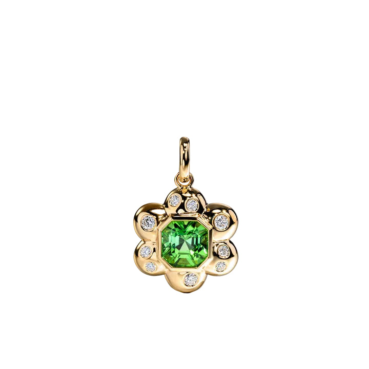 A gold flower-shaped pendant featuring a central green gemstone surrounded by small clear accent stones, shown on a light gray background.