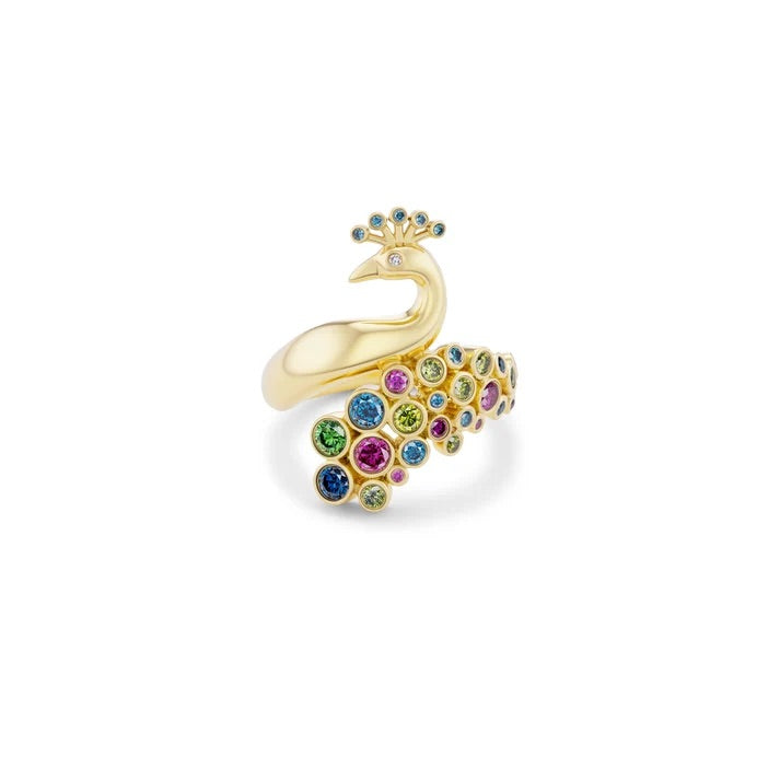 Gold peacock-shaped ring with colorful gemstones on a white background