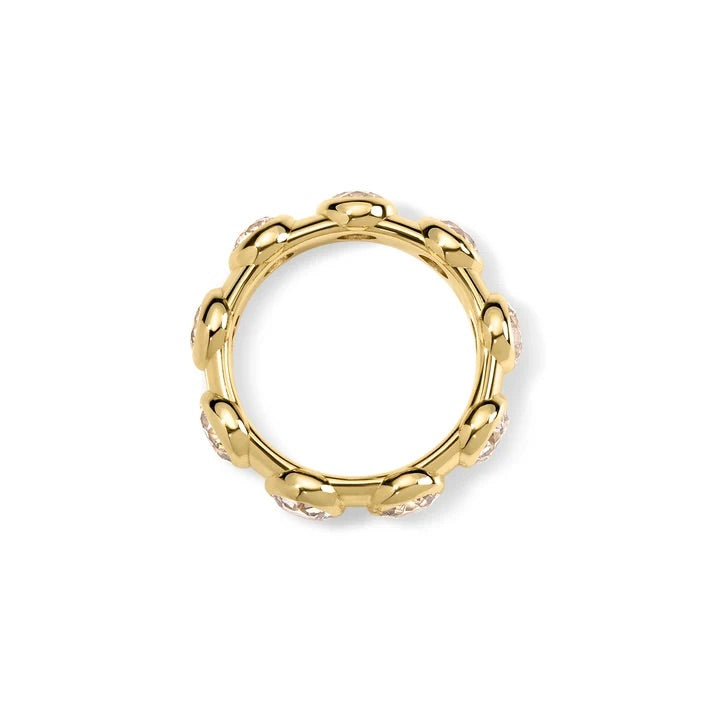 A gold ring with a scalloped, wavy outer edge and small clear stones set along the front, shown on a plain white background.