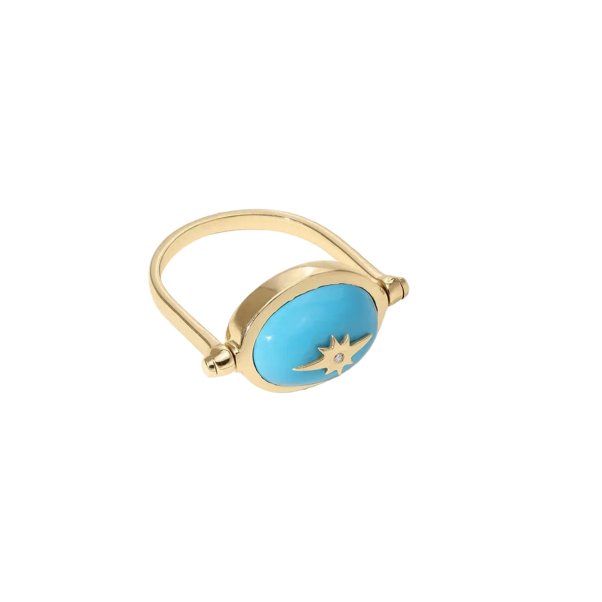 A gold ring with a large oval turquoise blue stone and a small gold compass rose detail on the face, photographed on a clean off-white background.