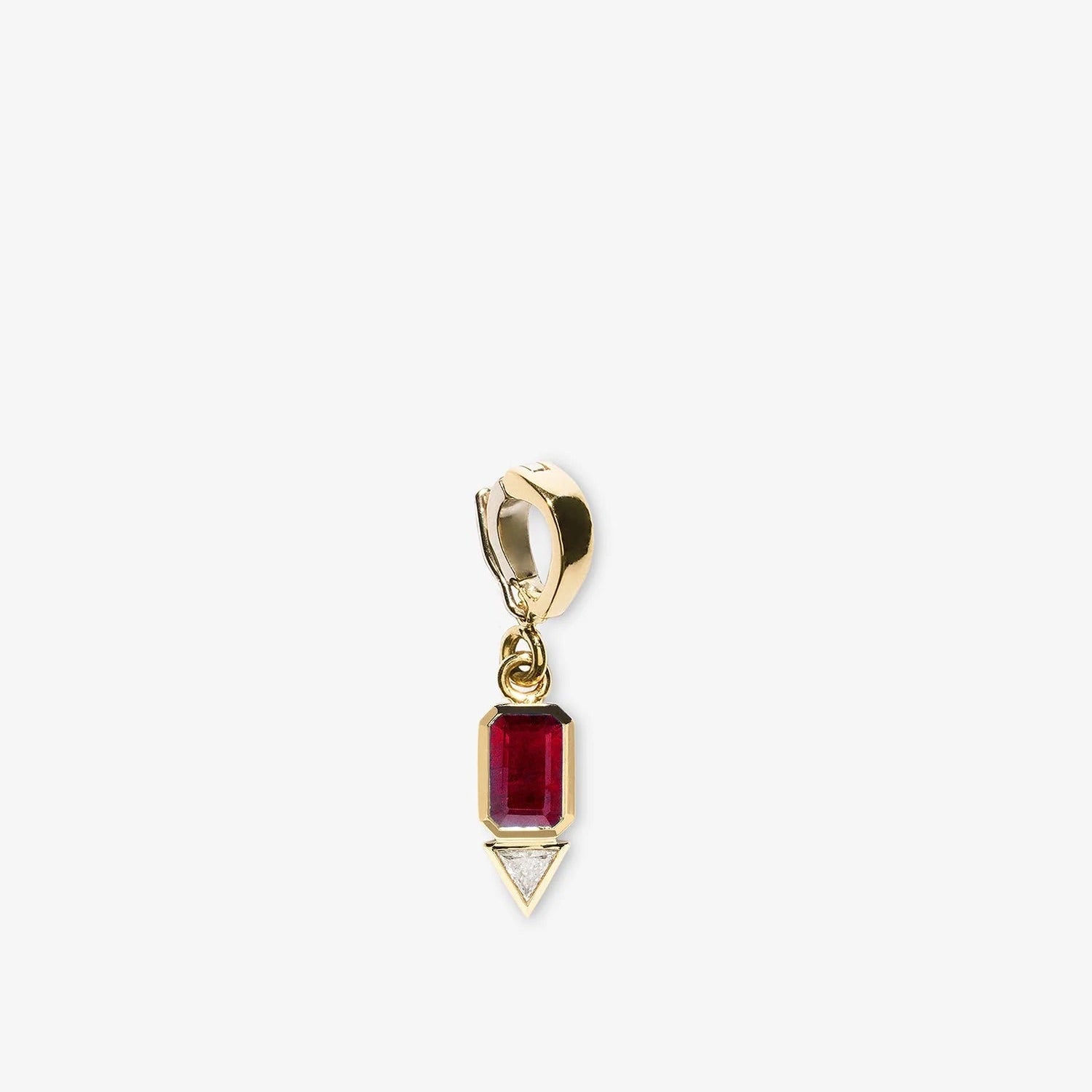 Gold pendant with a red gemstone on a white background