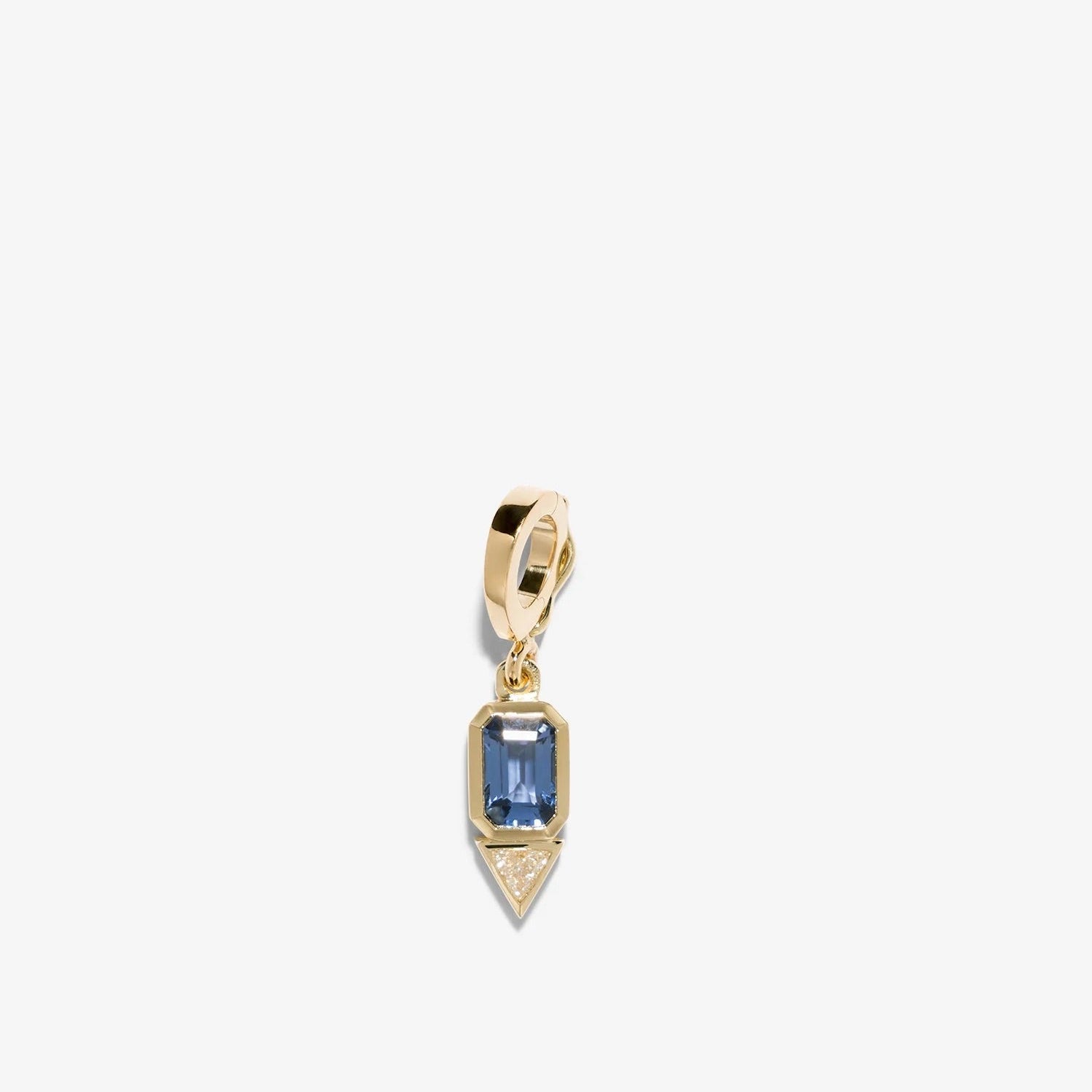 Gold pendant with a blue gemstone on a white background