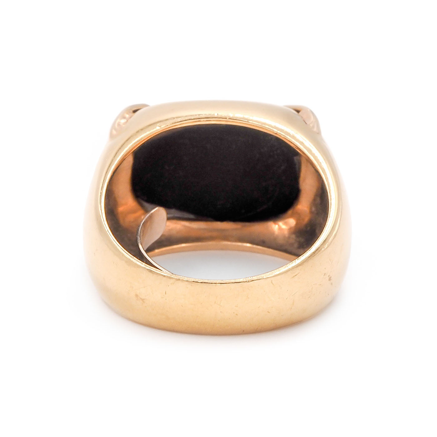 Gold ring with a black stone on a white background