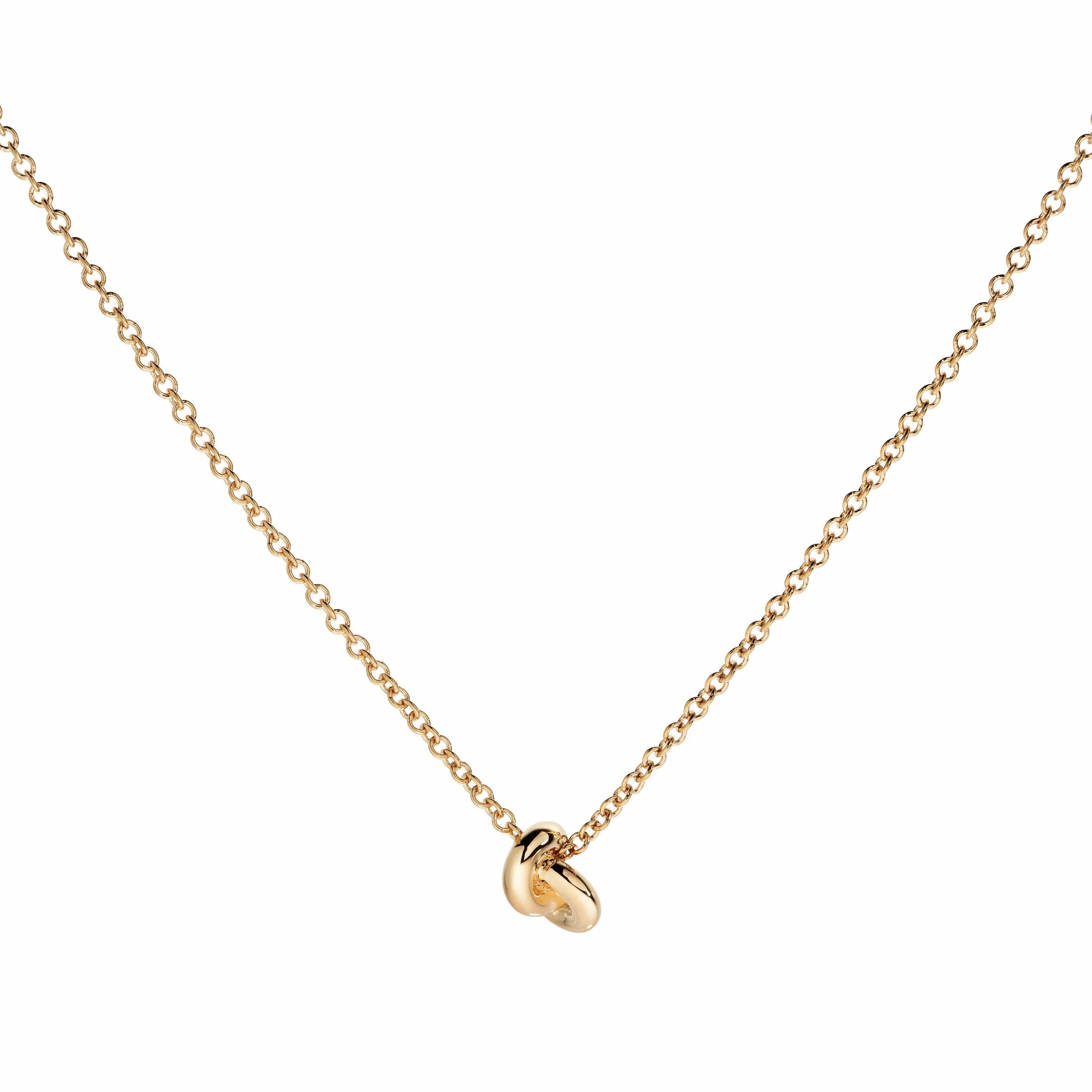 Gold necklace with a small pendant on a white background
