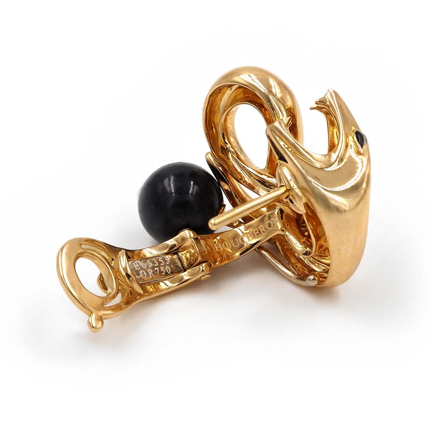 Gold and black jewelry piece on a white background