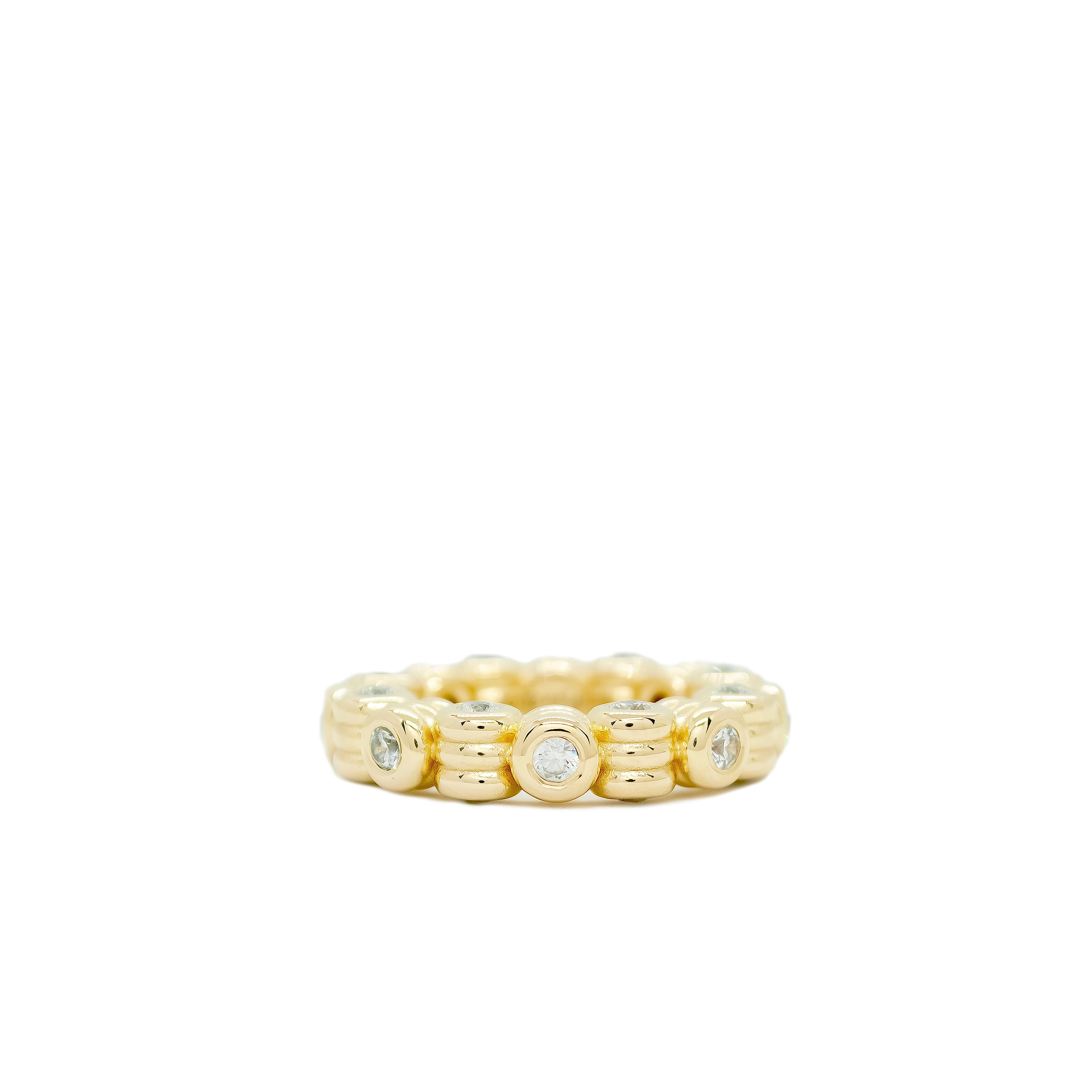 Gold ring with embedded diamonds on a white background