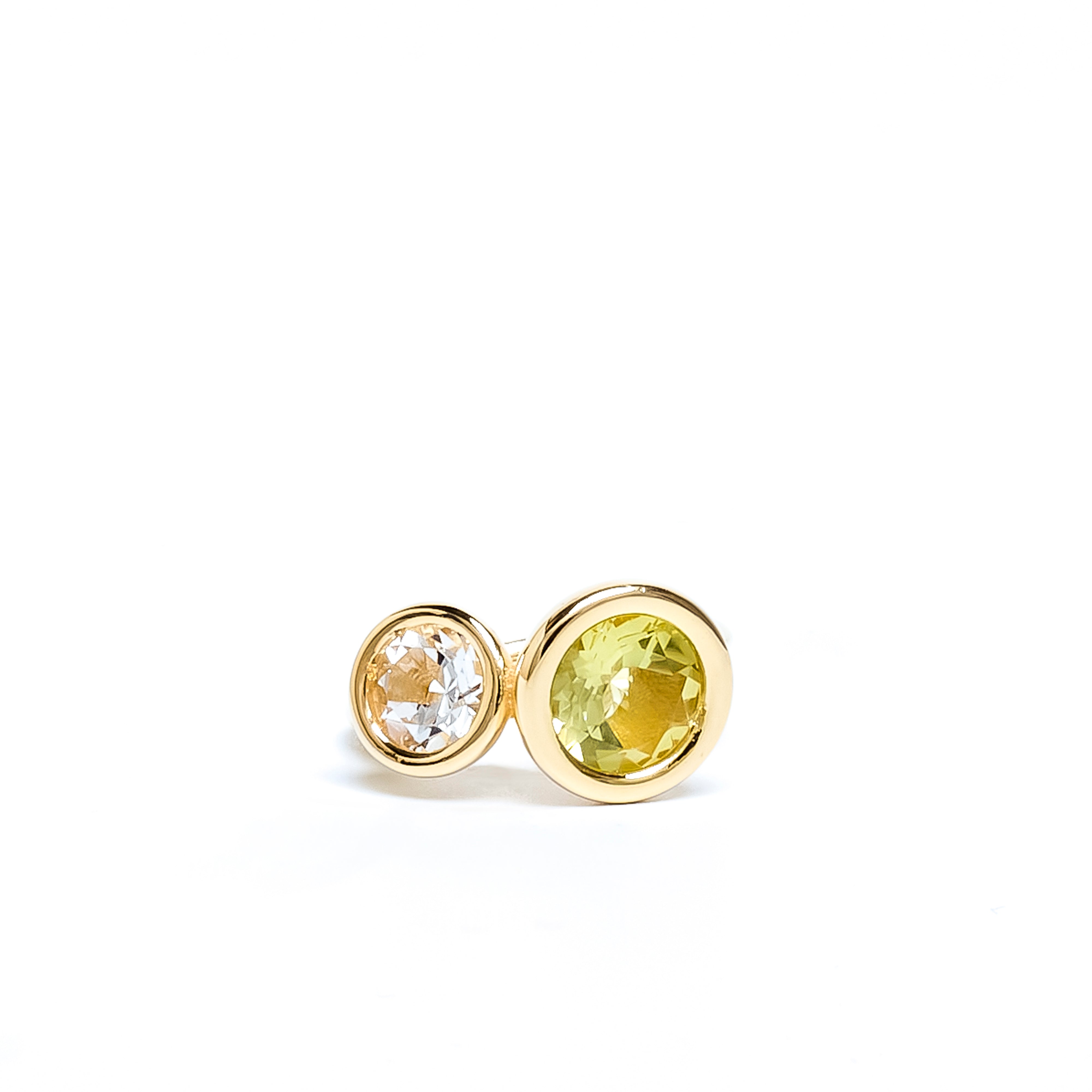 Pair of gold earrings with round gemstones on a white background