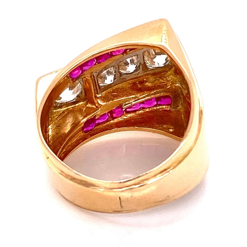 A gold teardrop-shaped ring featuring rows of clear cubic zirconia stones and bright pink gemstones on a white background.