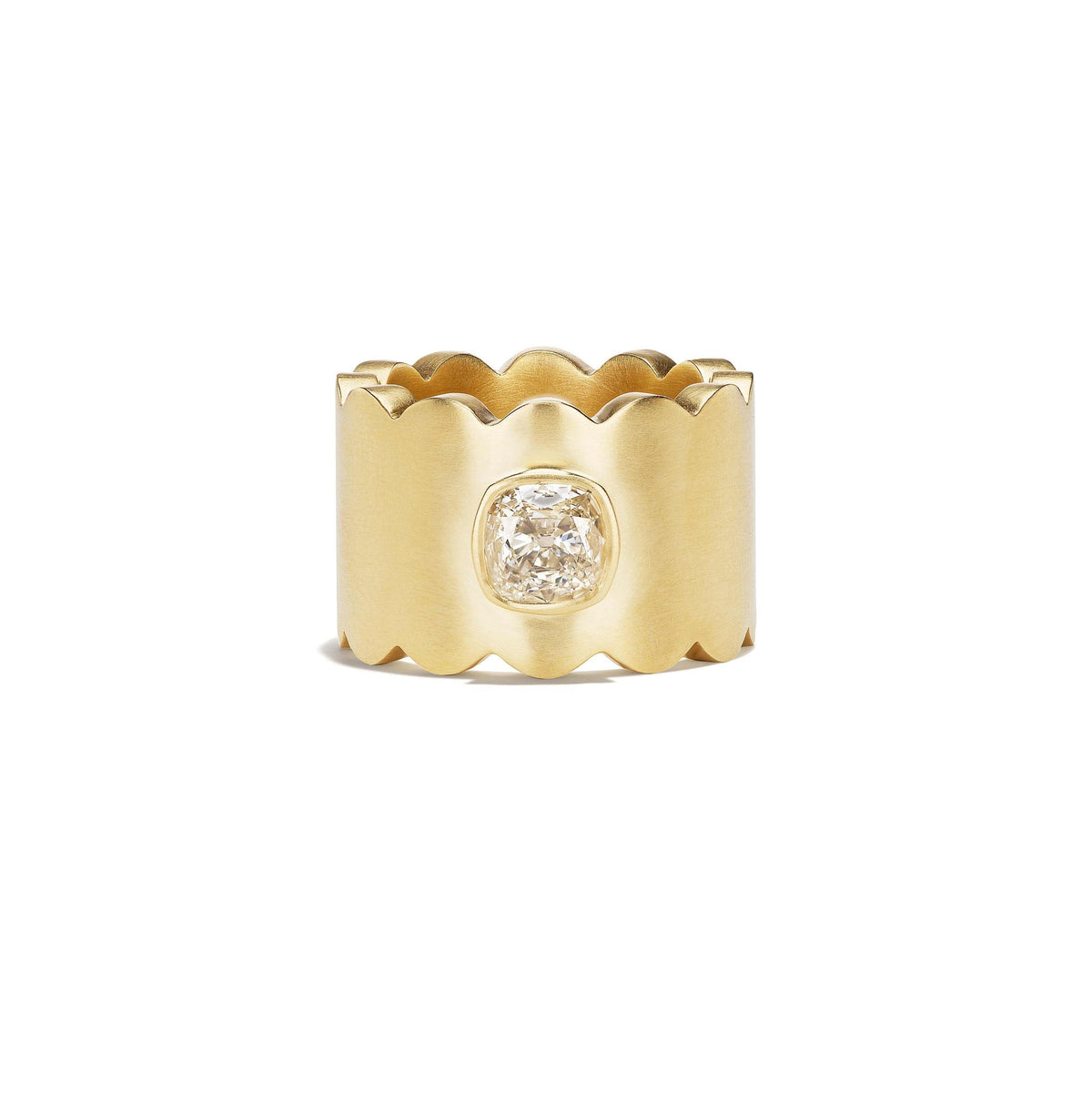 A wide yellow gold ring with a scalloped edge and a central cushion-cut diamond, shown on a plain white background.