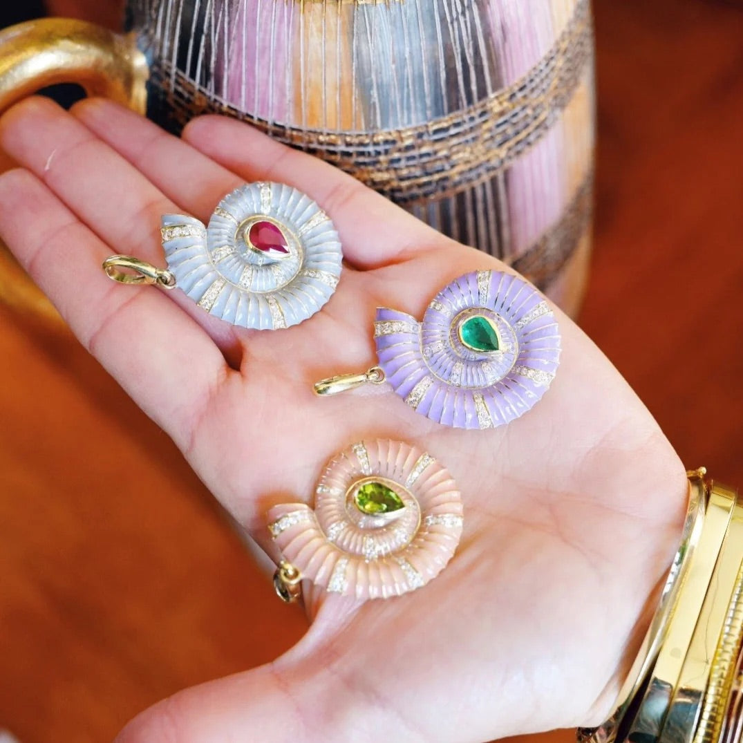Close-up of orange enamel shell charm with amethyst