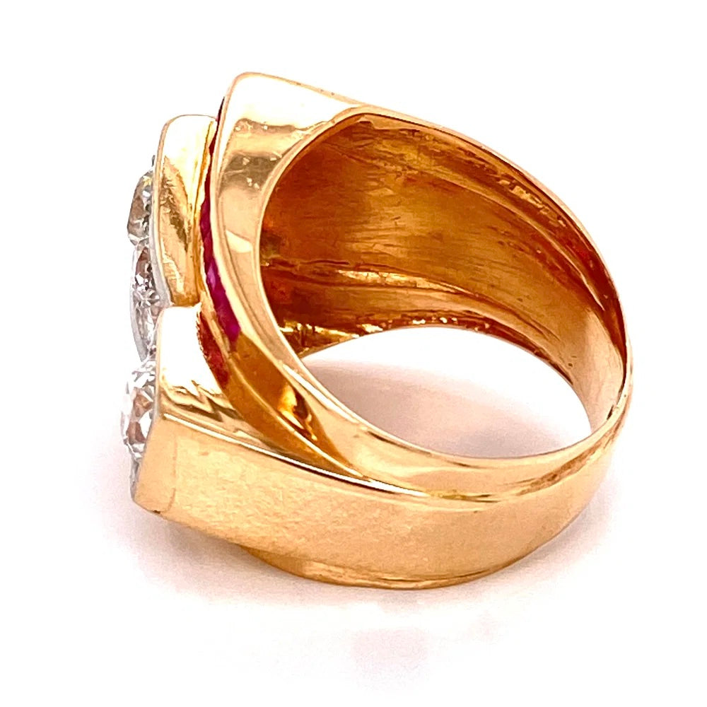 A gold signet-style ring with a wide polished band and a side setting holding clear gemstones, photographed on a white background.