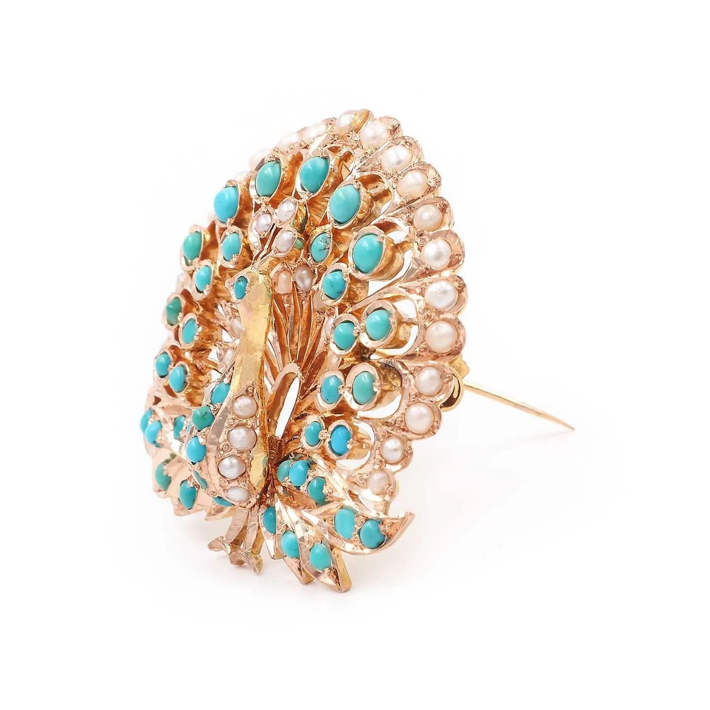 Gold brooch with turquoise stones and pearl accents on a white background