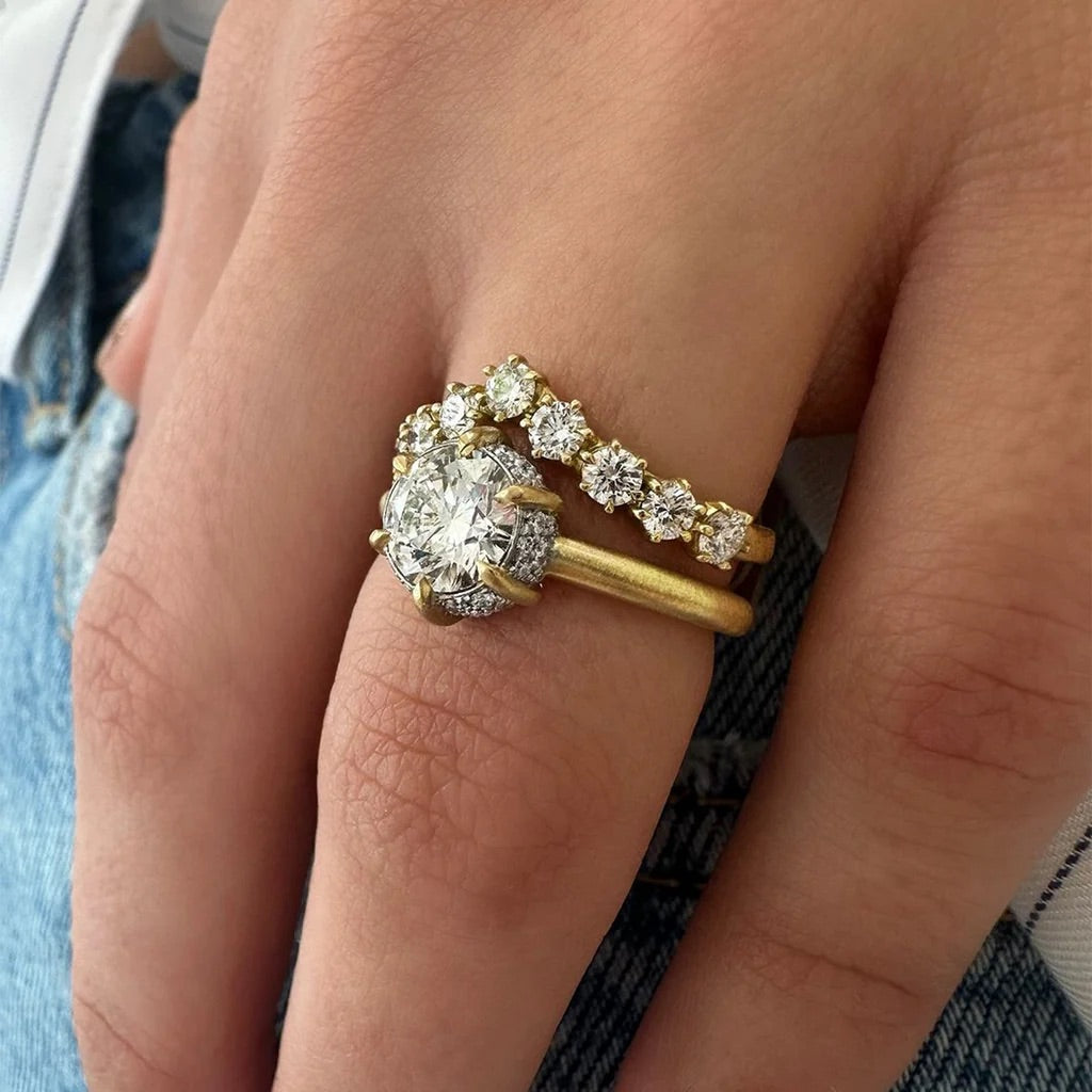 Gold ring with a large diamond on a finger