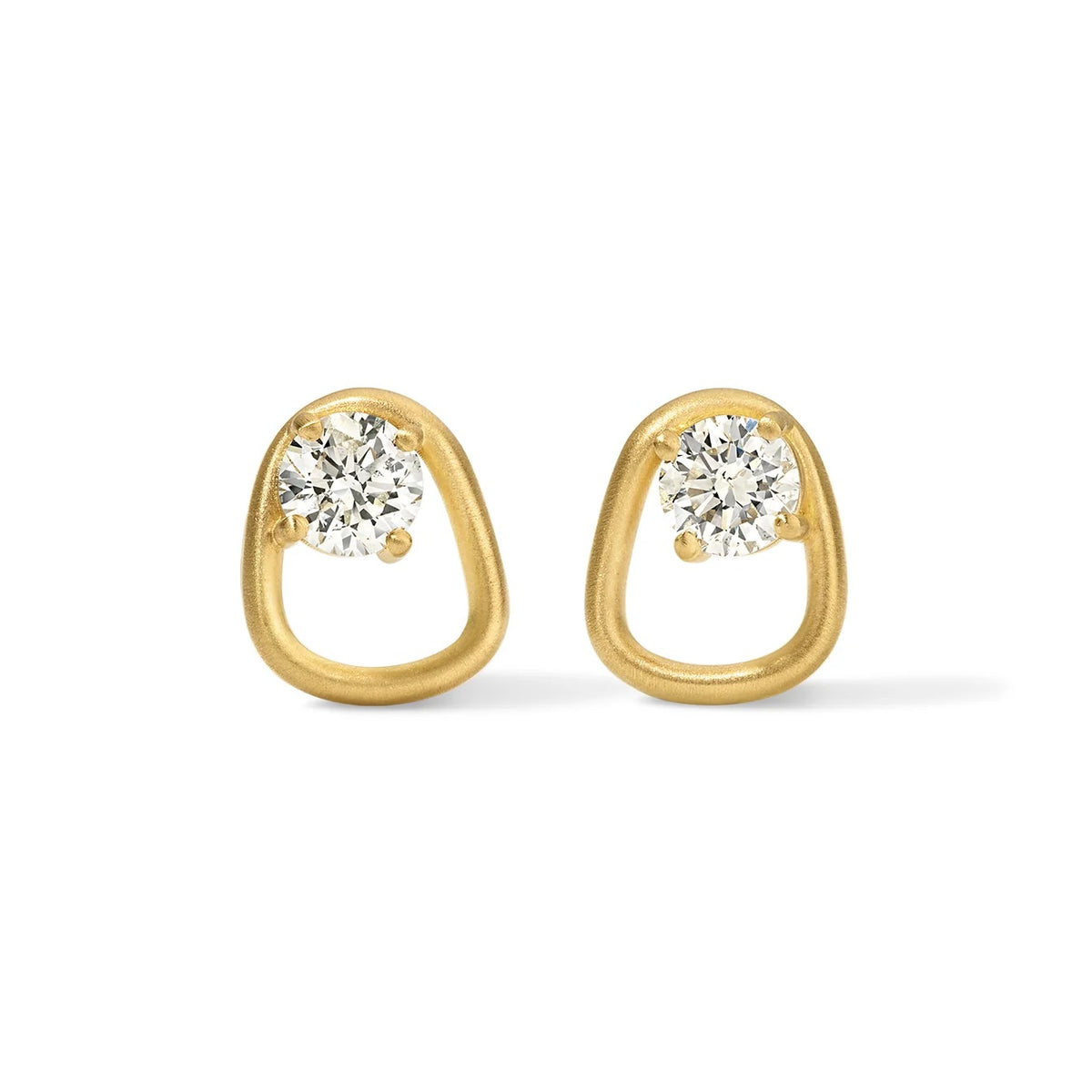 Gold earrings with clear gemstones on a white background