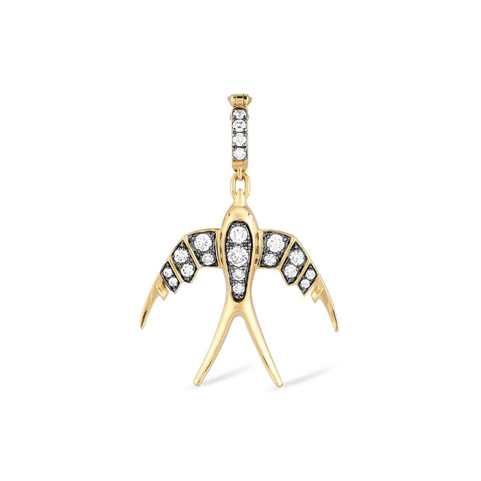 A gold swallow pendant featuring clear gemstones set in black and gold, shown against a plain white background.