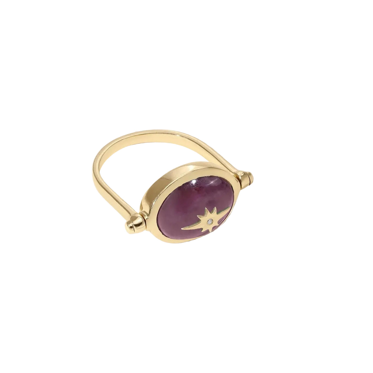 A gold ring with a large oval purple cabochon and a small gold starburst detail, photographed on a clean off-white background with a soft shadow.