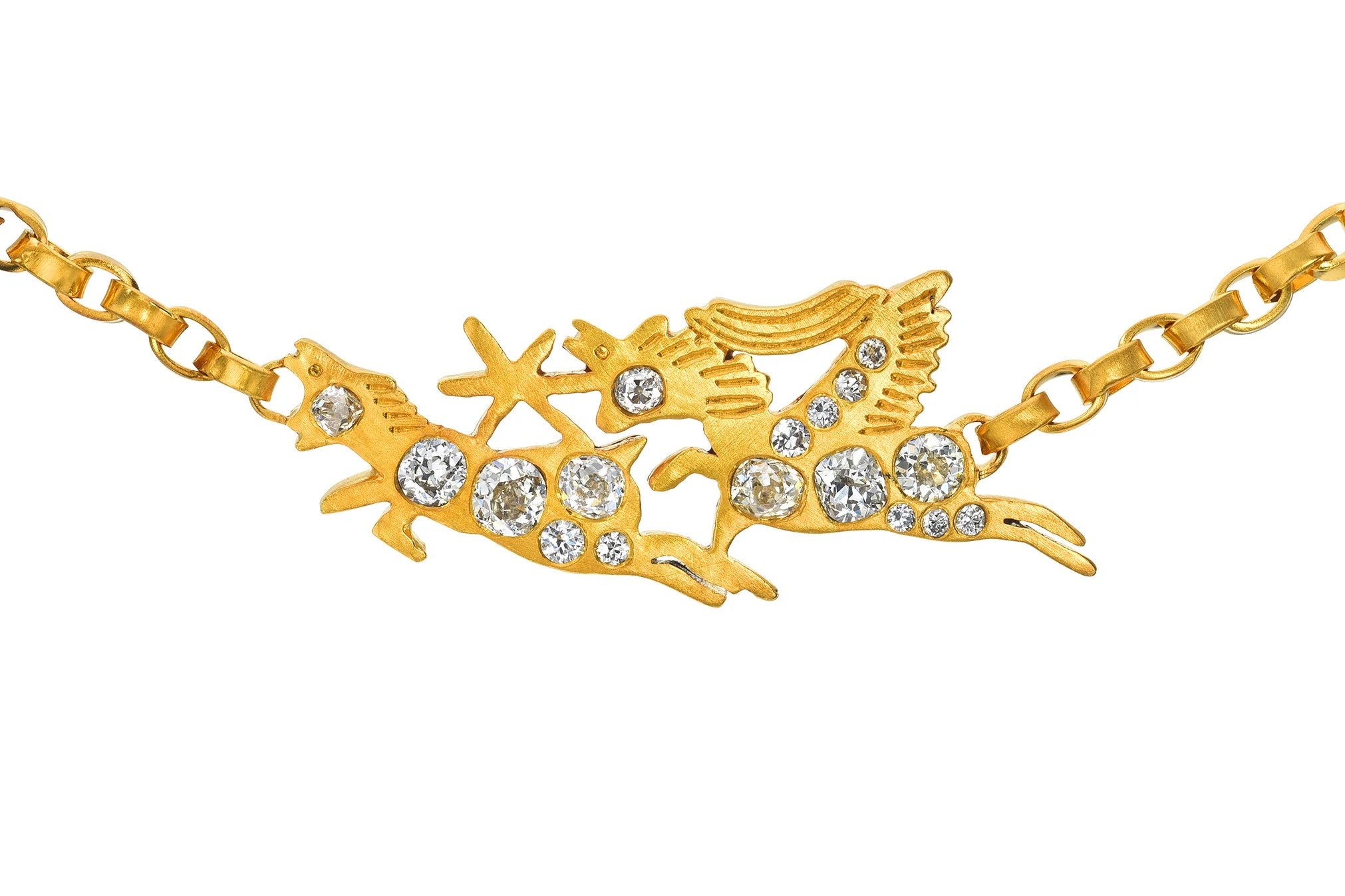 A gold-tone chain necklace featuring a central pendant with two stylized birds or fish figures adorned with clear rhinestones, shown on a plain white background.