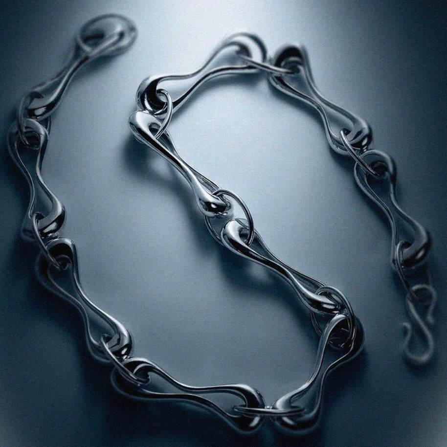 Silver bracelet on a reflective dark surface