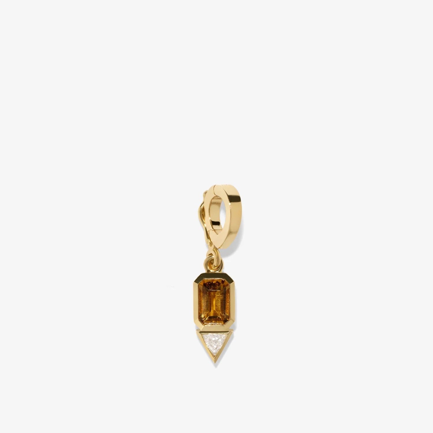 Gold pendant with a clear gemstone on a white background
