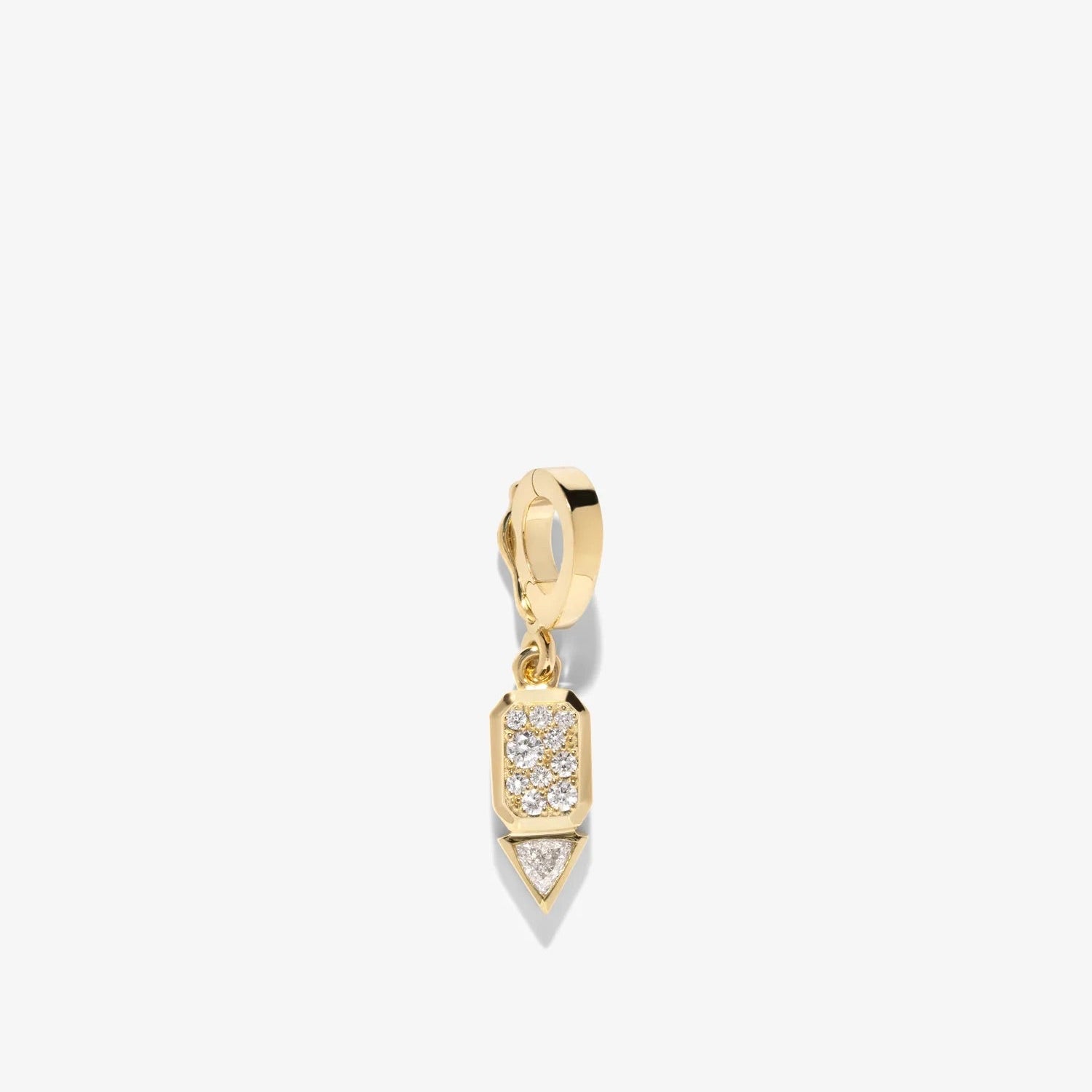 Gold pendant with a clear gemstone on a light beige background
