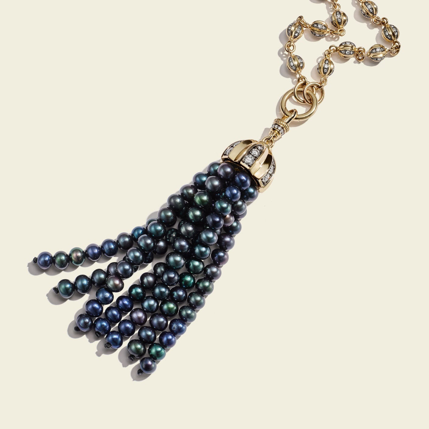 Necklace with blue beaded tassel on a beige background