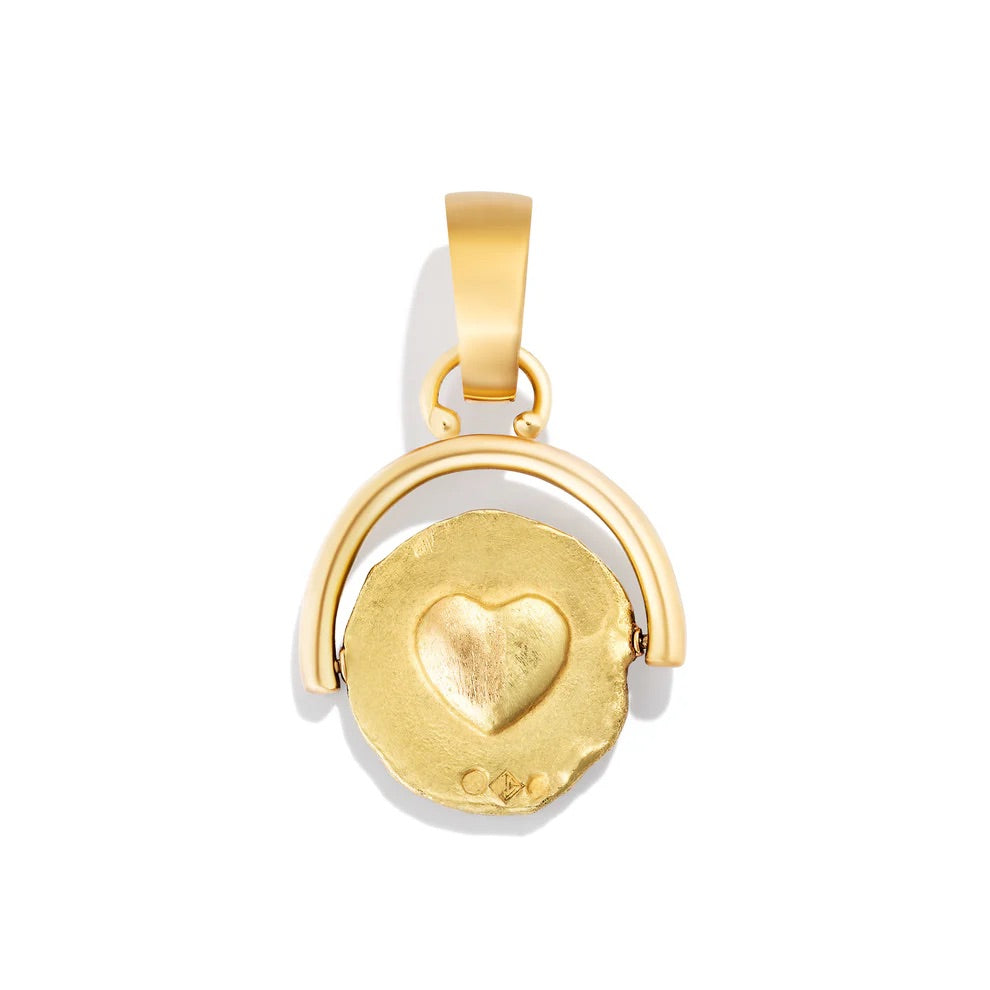 Gold pendant with heart design on a white background