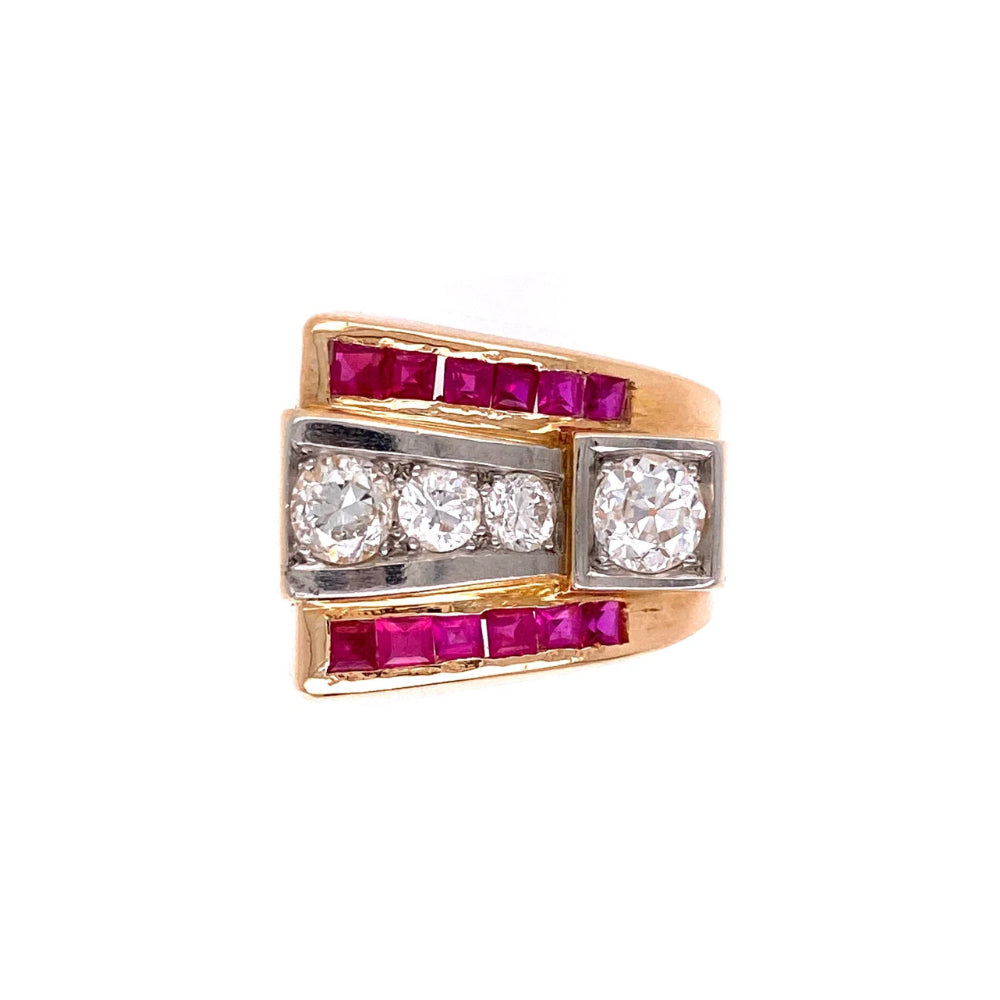 A vintage-style multi-stone ring featuring yellow gold, white gold, and pink gemstones. The ring has a gold band with rows of square pink rubies, a central horizontal section with three round clear diamonds set in white gold, and a vertical section with a single round clear diamond set in gold.