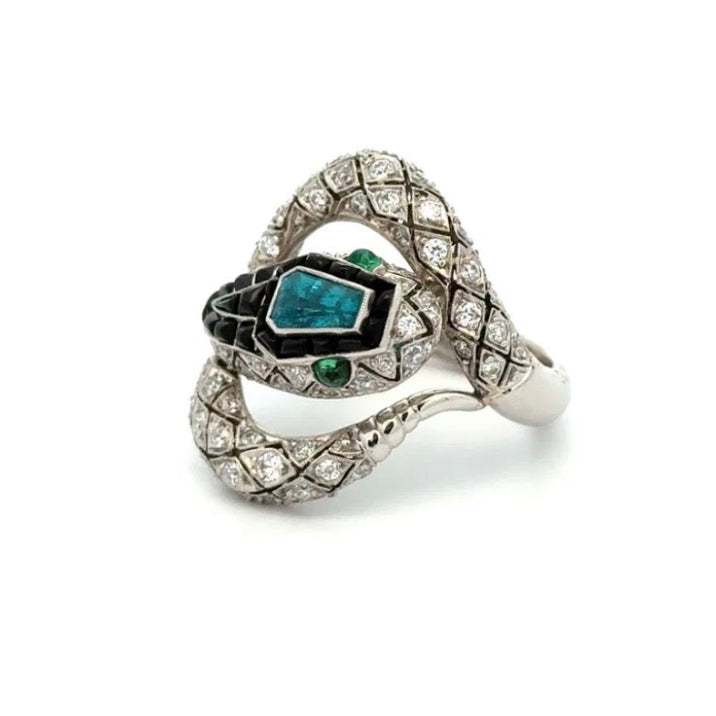 Elegant ring with emerald and diamond accents on a white background
