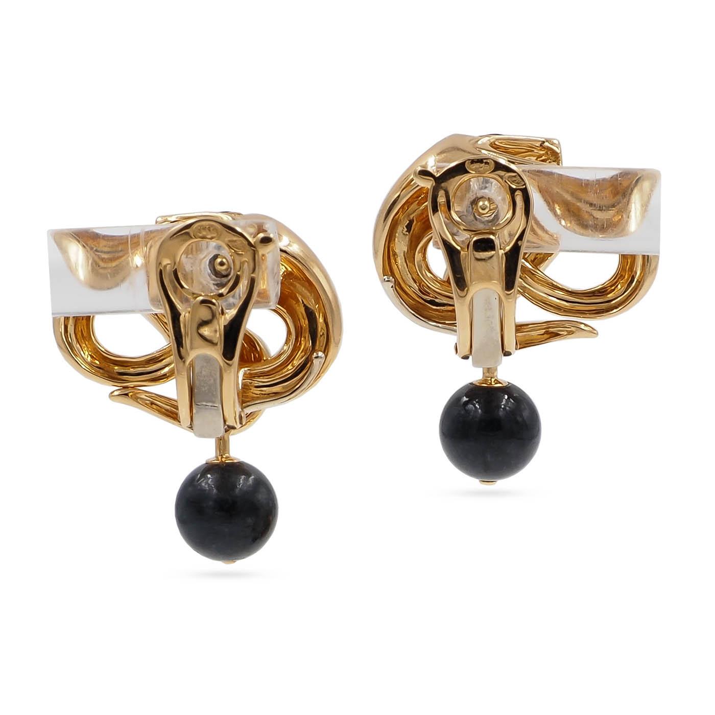 Gold and black earrings on a white background