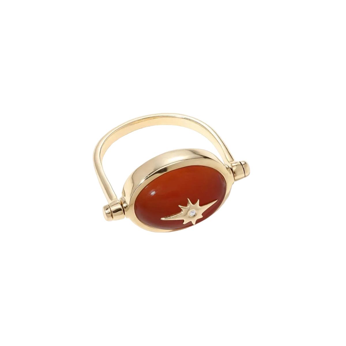 A gold-plated ring featuring an oval cabochon red stone with a small white star inlay, set against a clean off-white background.