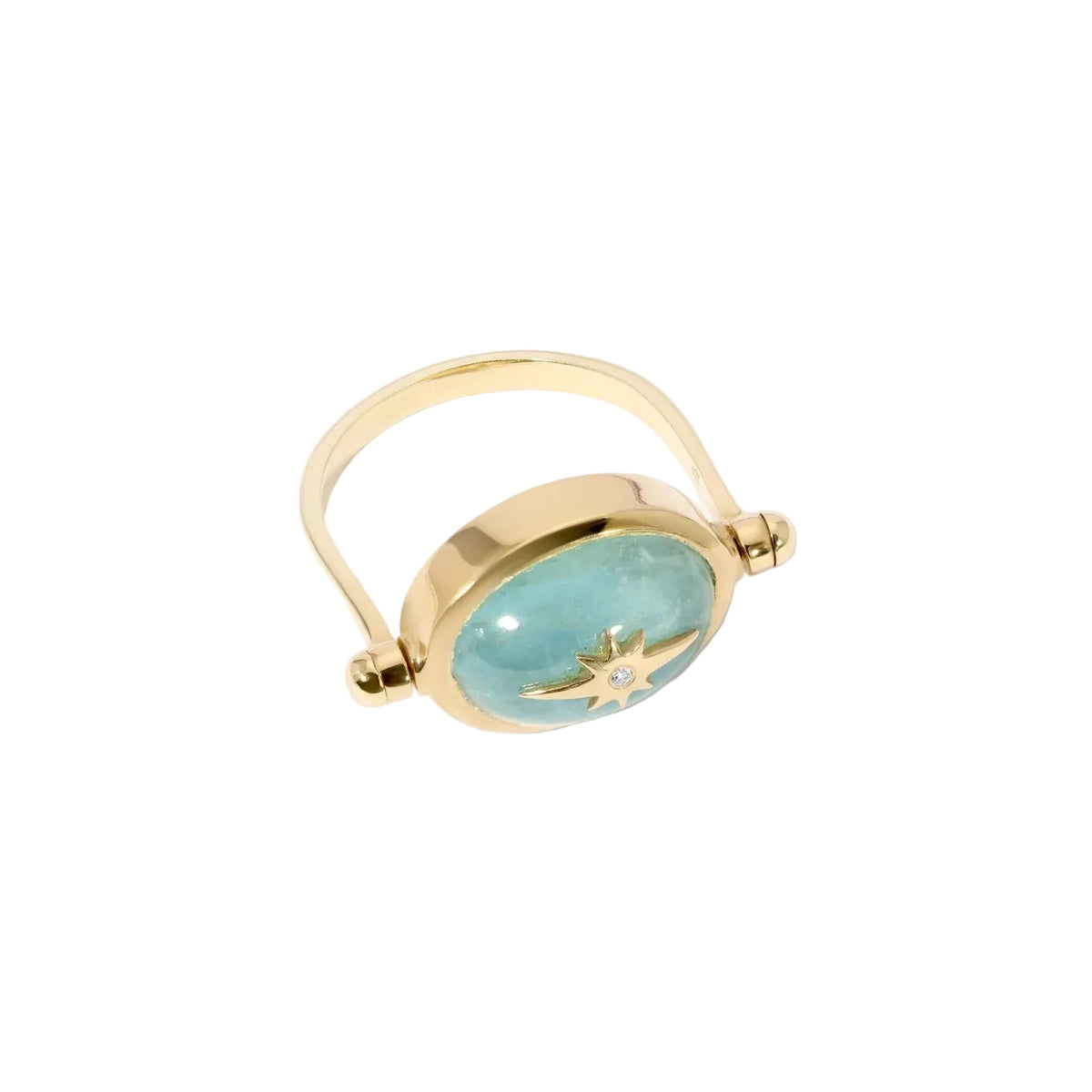 A gold ring featuring a large oval light blue stone with a gold star motif in the center, set against a clean off-white background.