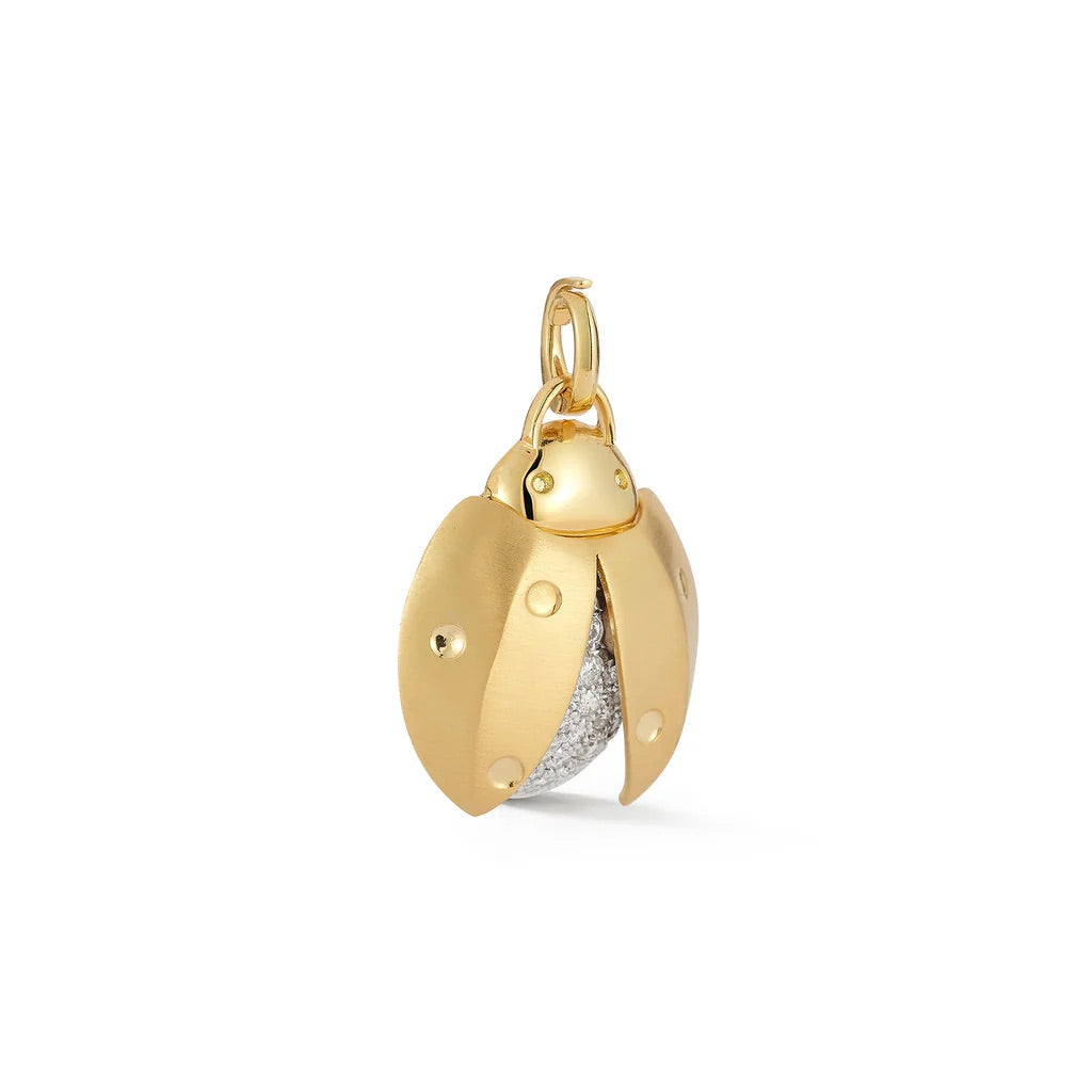 Gold pendant with a white gemstone on a white background
