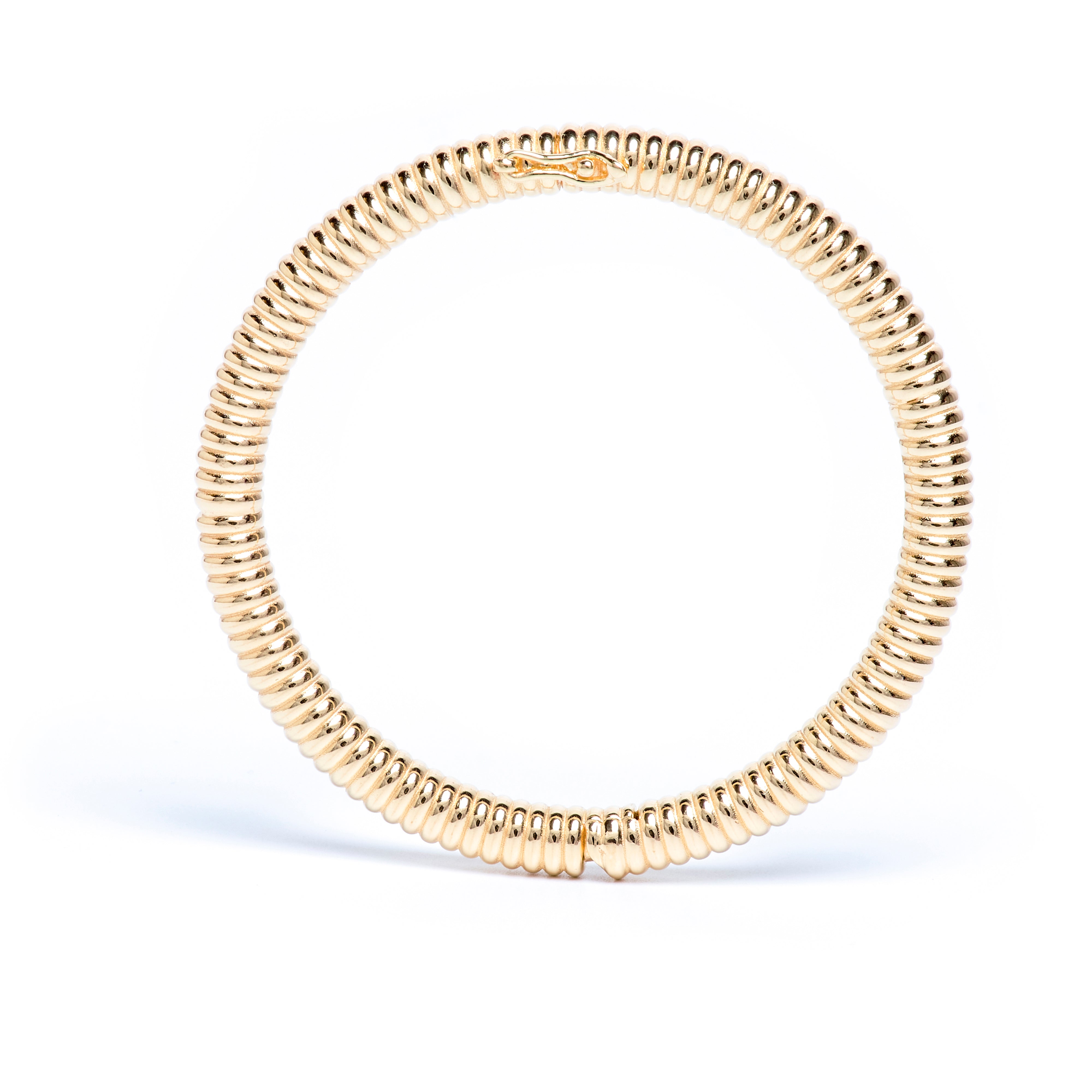 Gold beaded bracelet on a white background