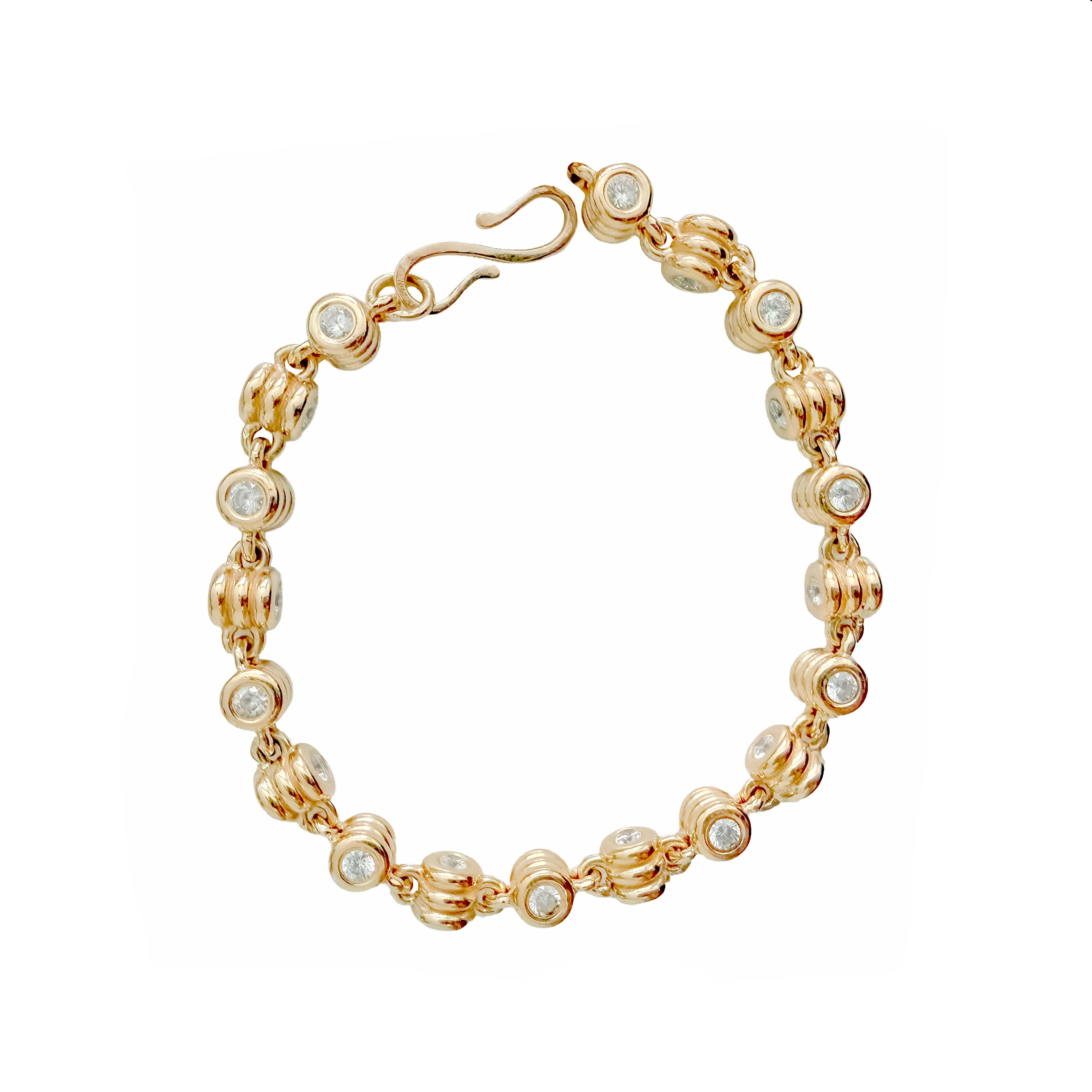 Gold bracelet with embedded diamonds on a white background