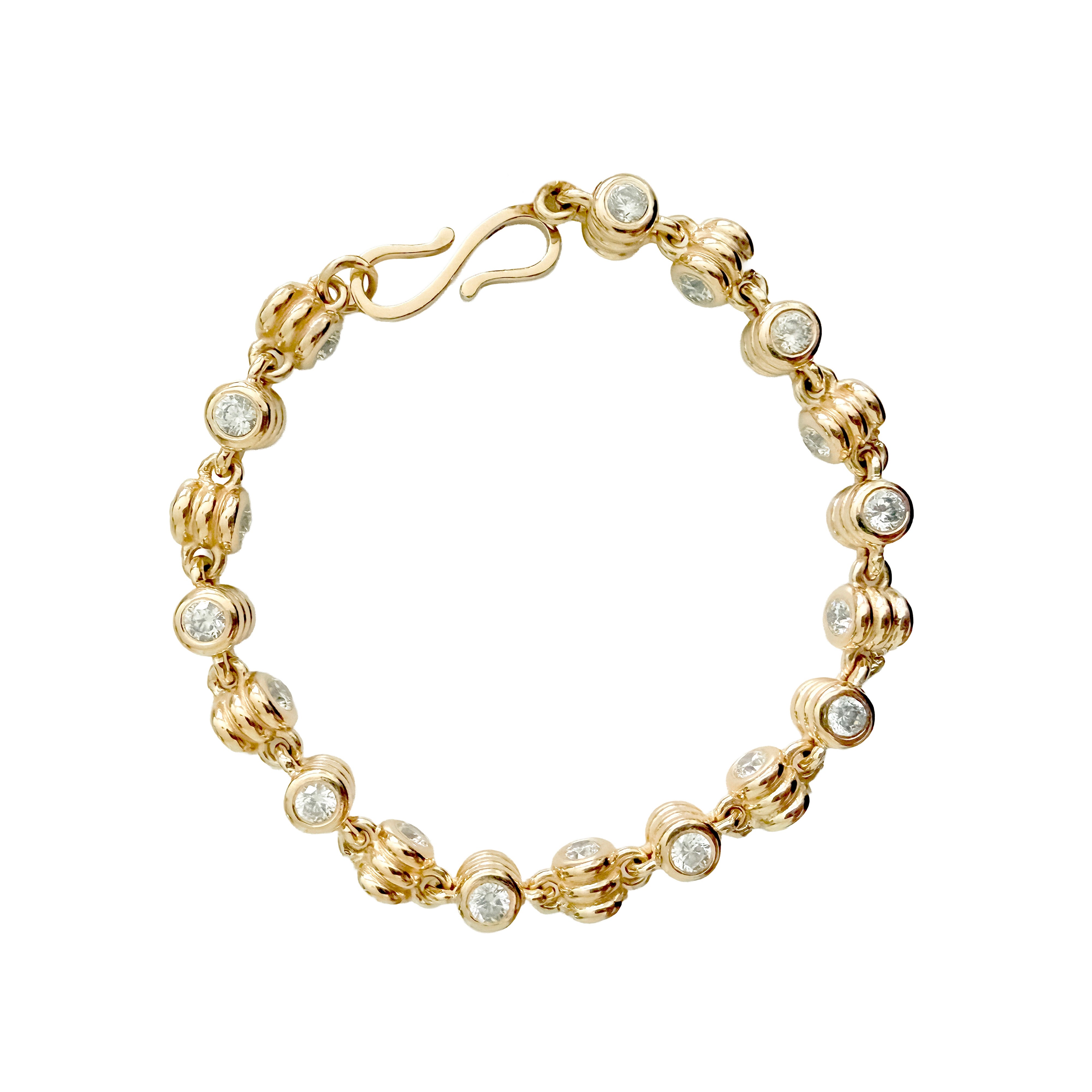 Gold bracelet with diamond beads on a white background