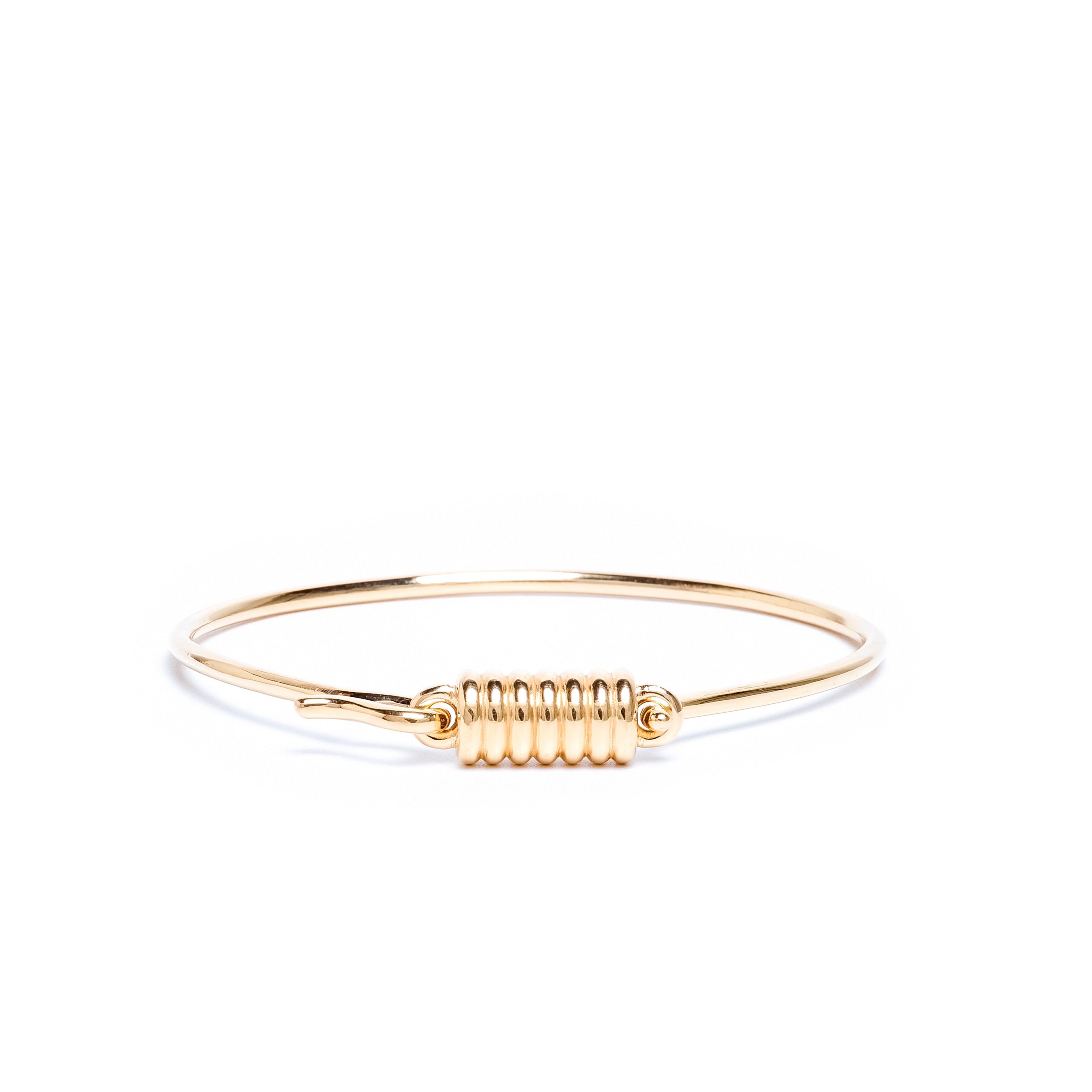 Gold bracelet with a unique design on a white background