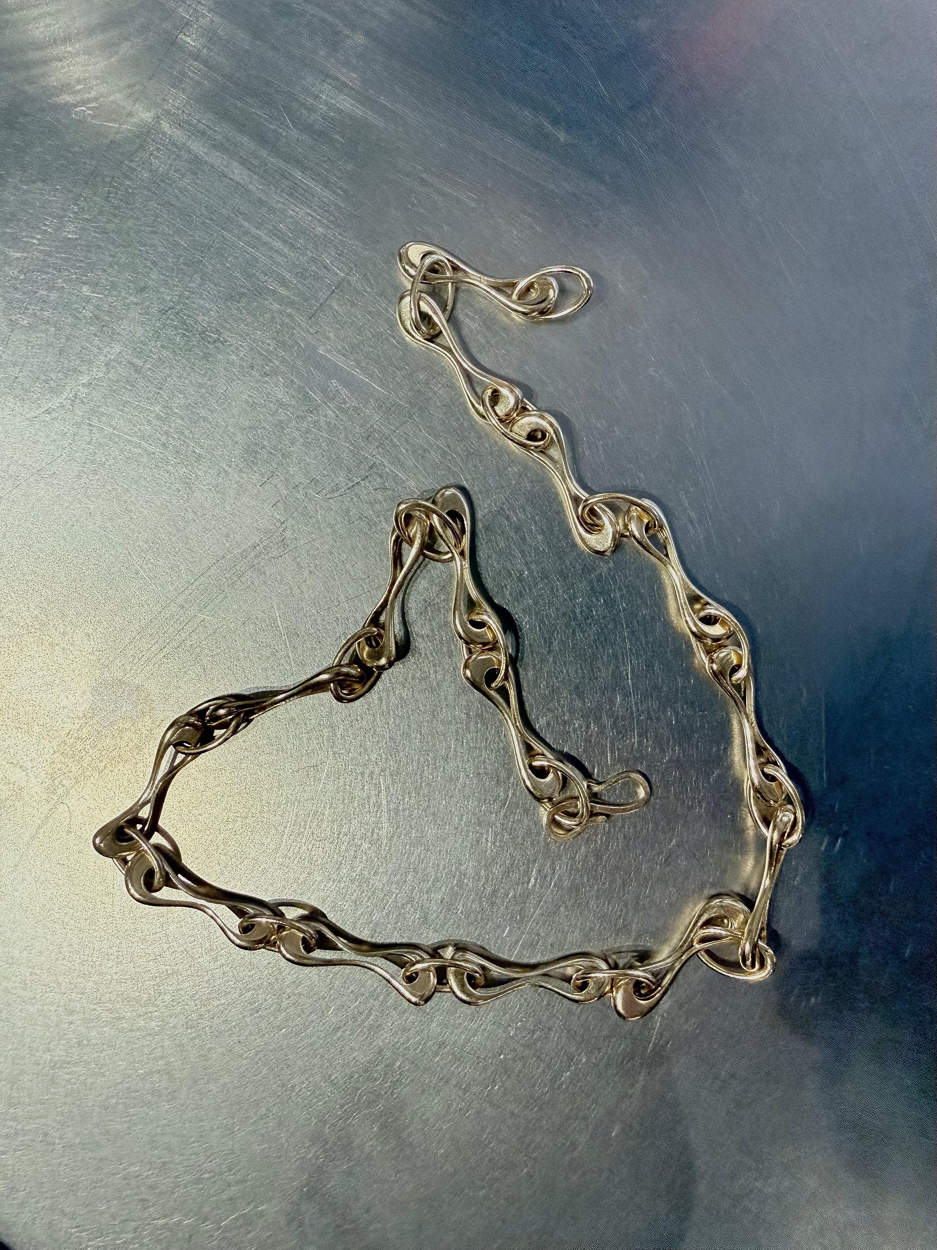Gold chain on a metallic surface
