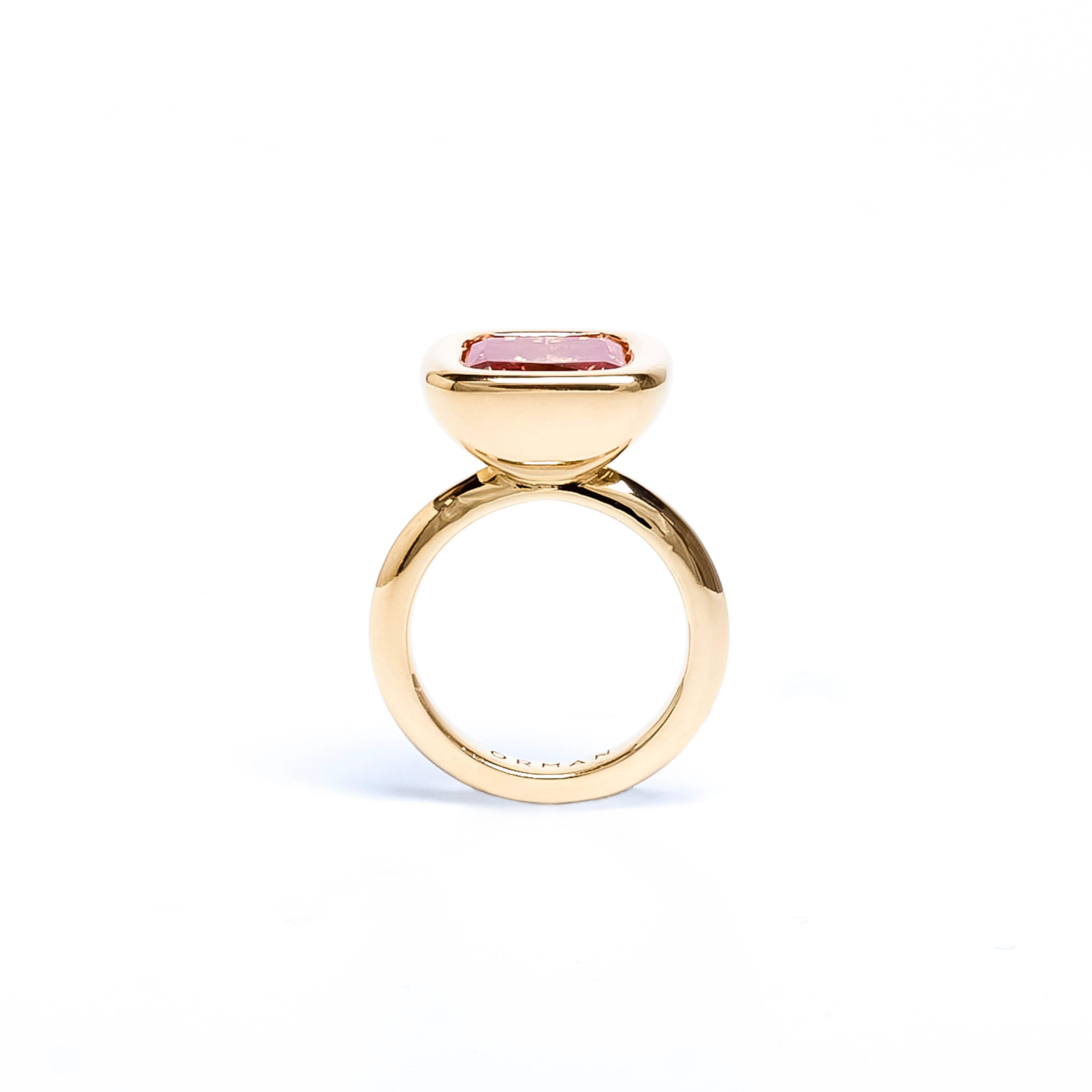 Gold ring with a pink gemstone on a white background
