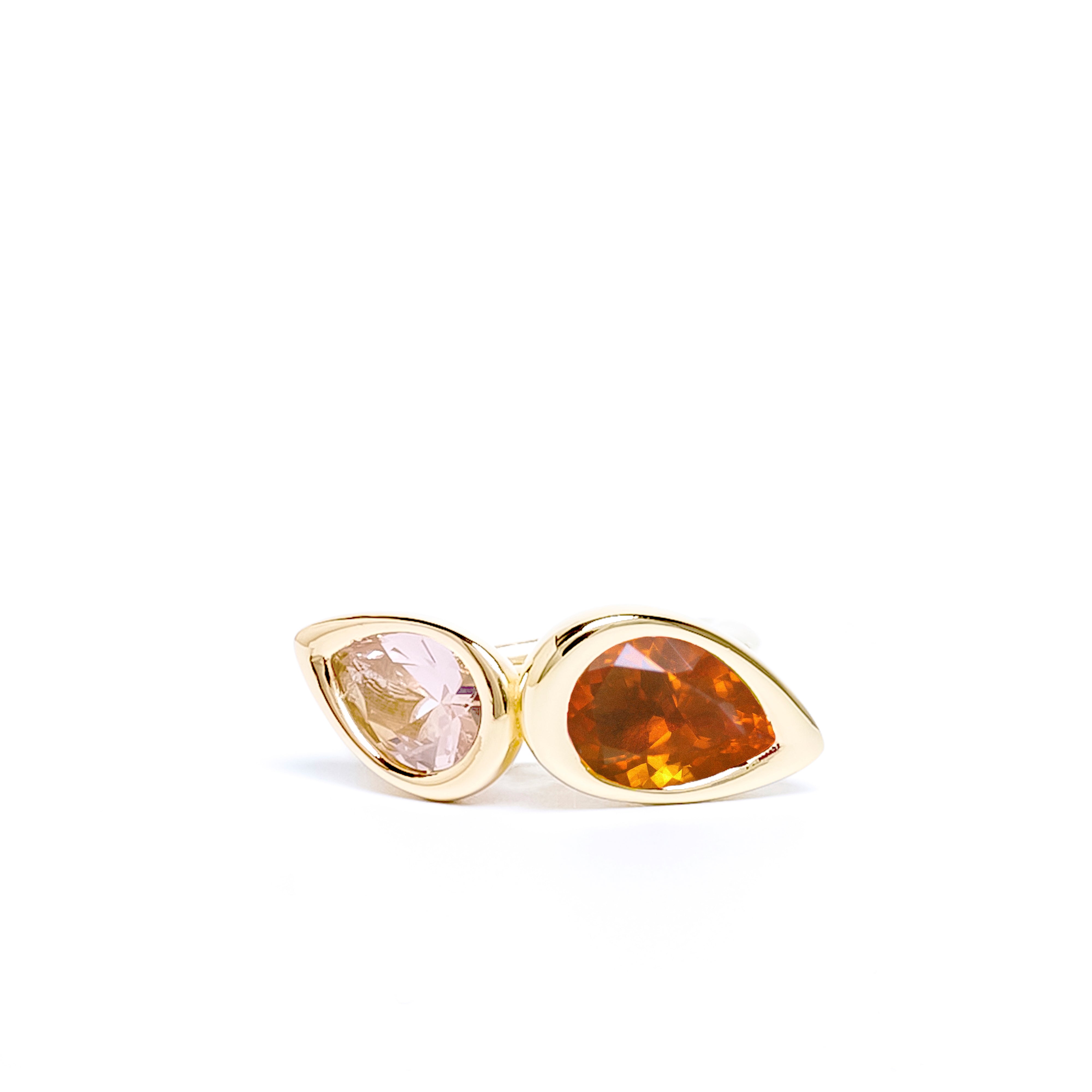 Gold earrings with teardrop-shaped gemstones on a white background
