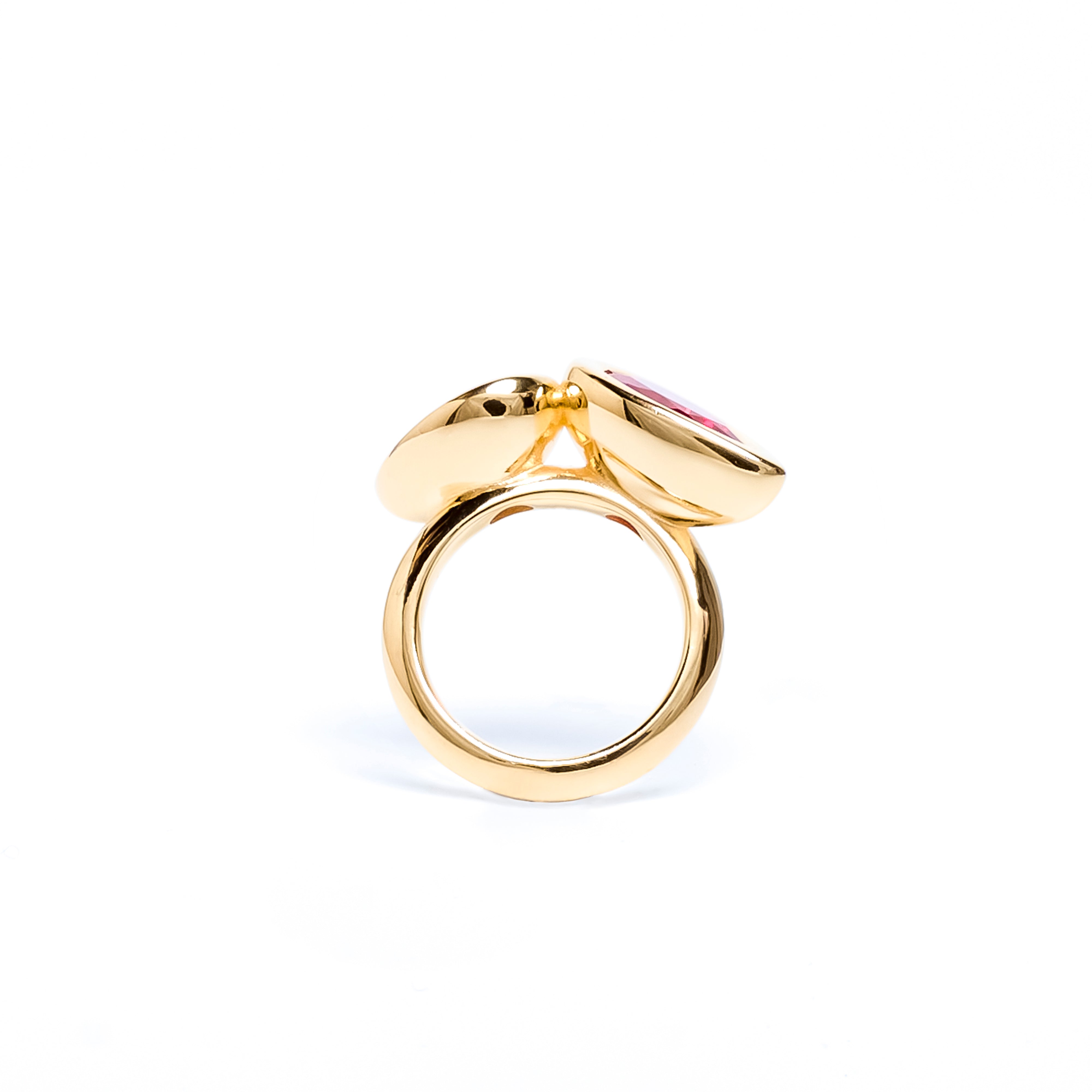 Gold ring with a pink gemstone on a white background