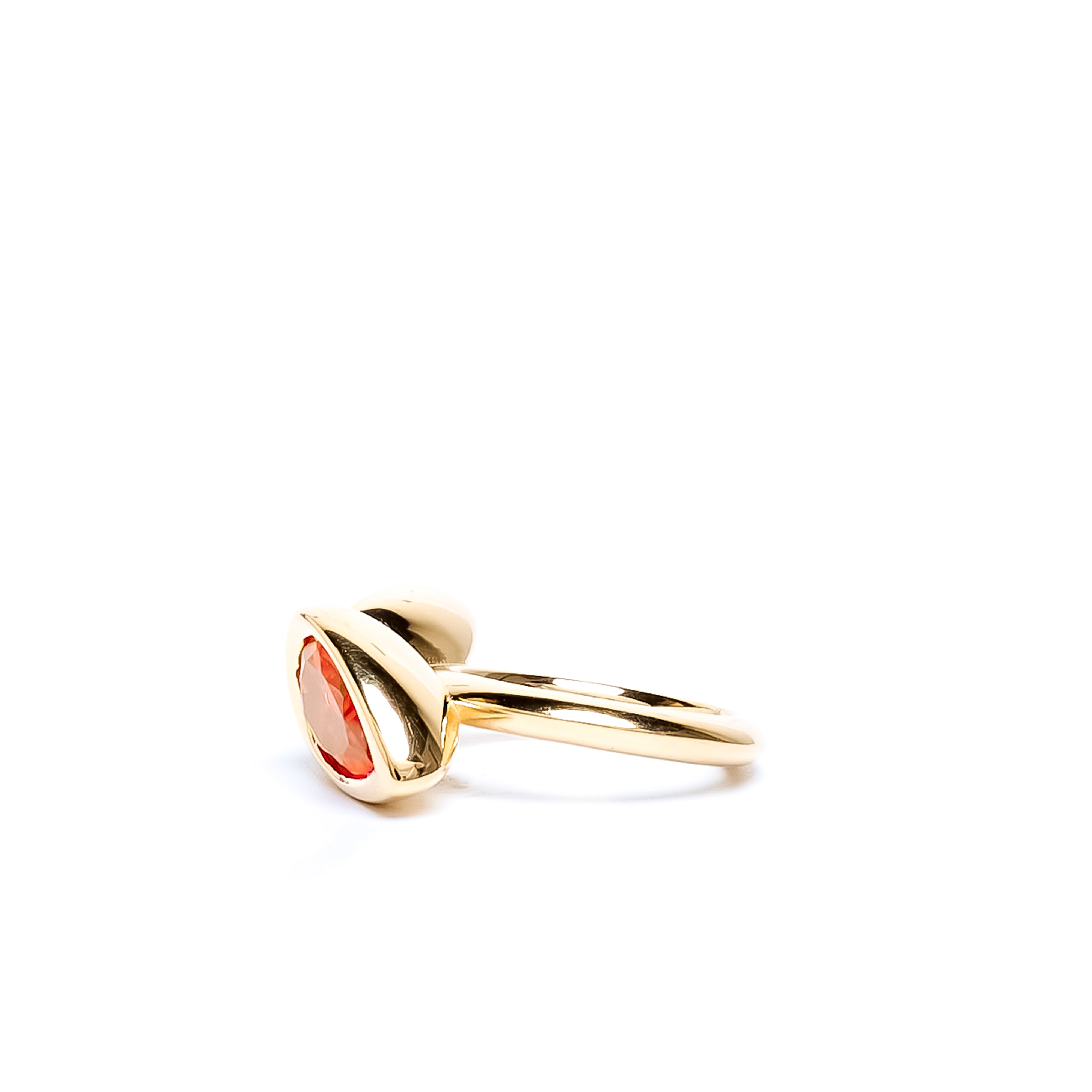 Gold ring with a red gemstone on a white background